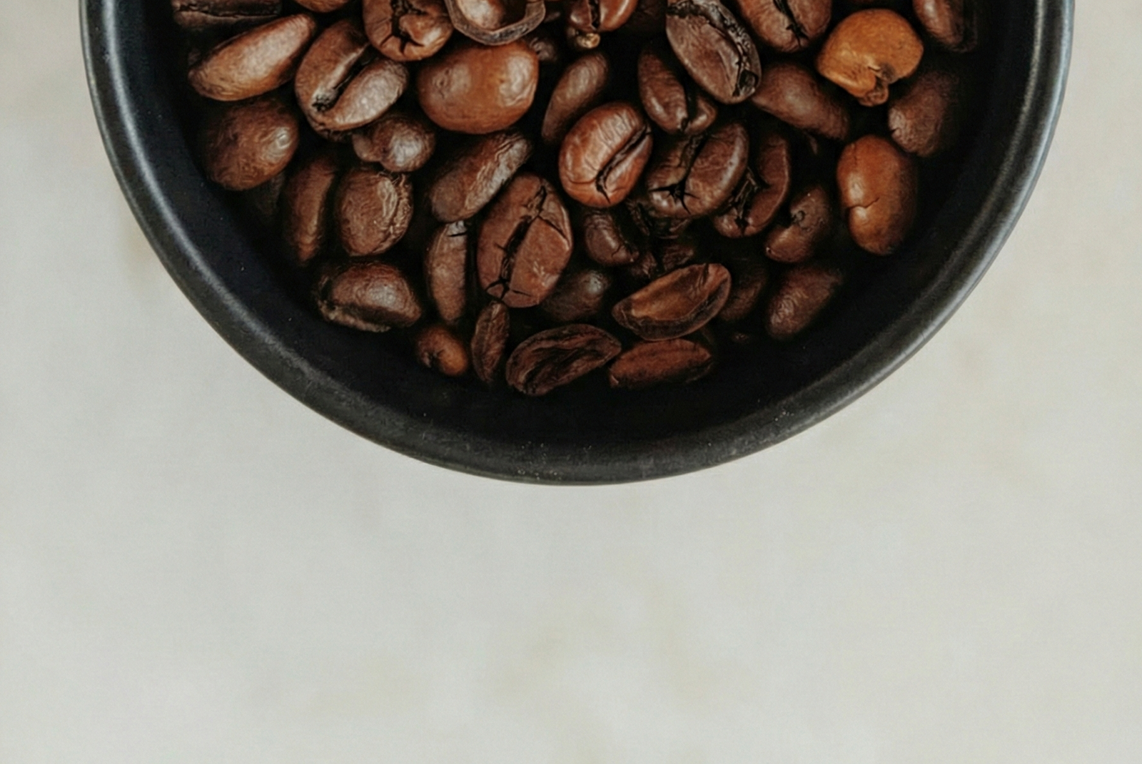 Black cup of UK specialty roasted coffee beans